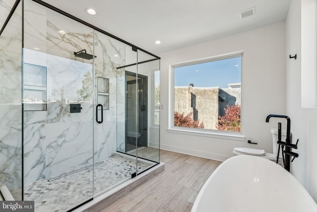 bathroom with hardwood / wood-style flooring and plus walk in shower