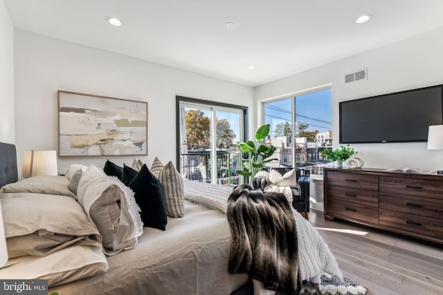 bedroom featuring access to exterior and light hardwood / wood-style flooring