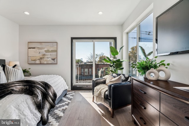 bedroom featuring light wood-type flooring and access to outside