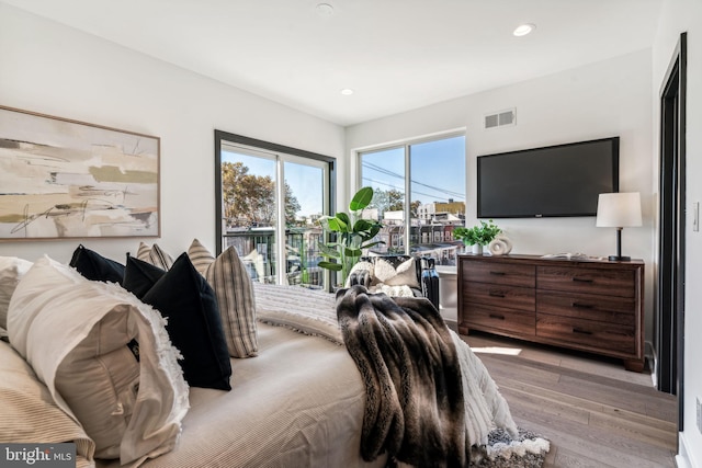 bedroom with access to outside and light hardwood / wood-style floors