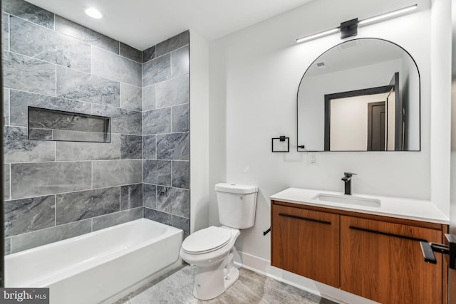 full bathroom with vanity, tiled shower / bath combo, and toilet