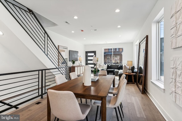 dining space with light hardwood / wood-style flooring