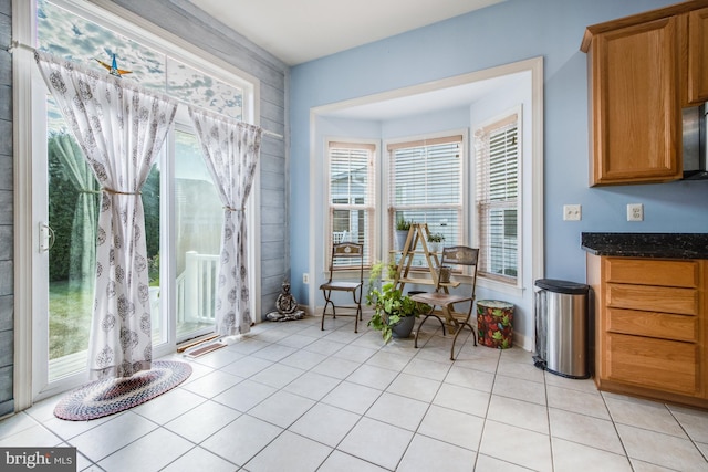 dining room with light tile patterned flooring and plenty of natural light