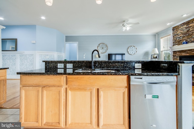 kitchen featuring light brown cabinets, a sink, ceiling fan, and stainless steel dishwasher