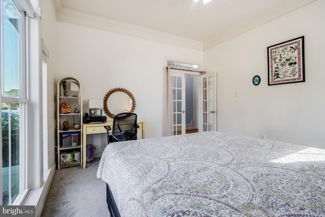carpeted bedroom featuring a ceiling fan and crown molding