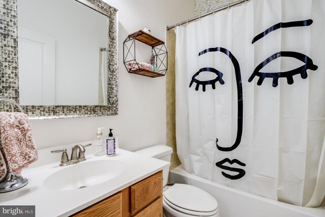 full bathroom featuring toilet, shower / bath combo with shower curtain, and vanity