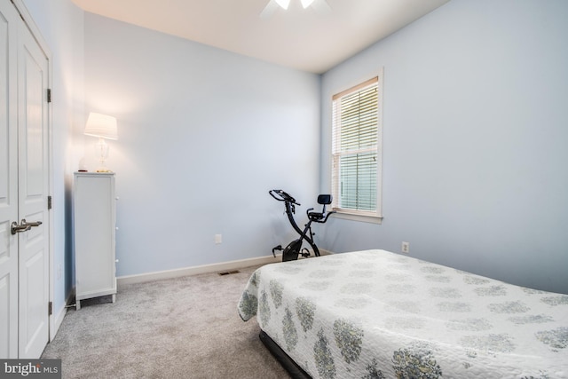 carpeted bedroom with baseboards, ceiling fan, and visible vents