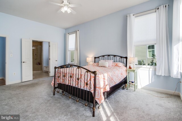 bedroom featuring carpet floors, connected bathroom, and ceiling fan