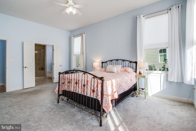 carpeted bedroom featuring baseboards and a ceiling fan