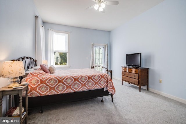 carpeted bedroom featuring ceiling fan and baseboards