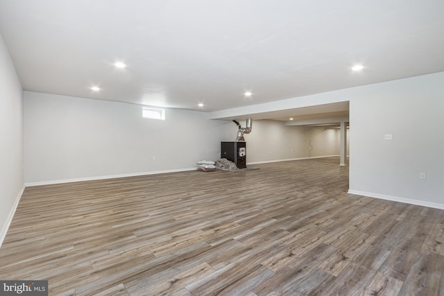 below grade area with wood finished floors, baseboards, and recessed lighting