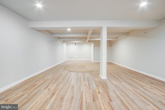 basement with light hardwood / wood-style flooring