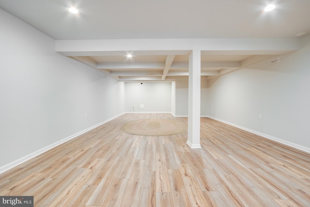 finished below grade area with baseboards, recessed lighting, and wood finished floors