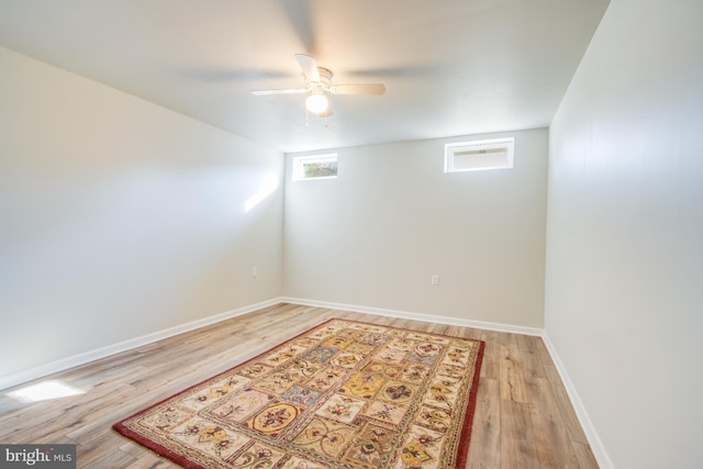 spare room with light wood-style floors, baseboards, and ceiling fan
