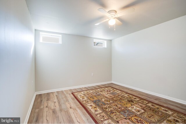 basement with wood-type flooring and ceiling fan