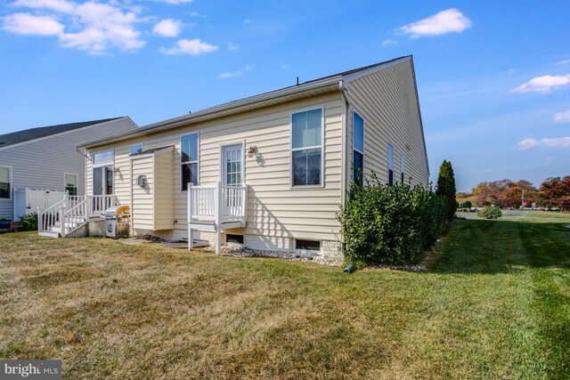 rear view of property with a yard