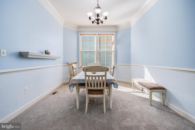 carpeted dining space with crown molding and a chandelier