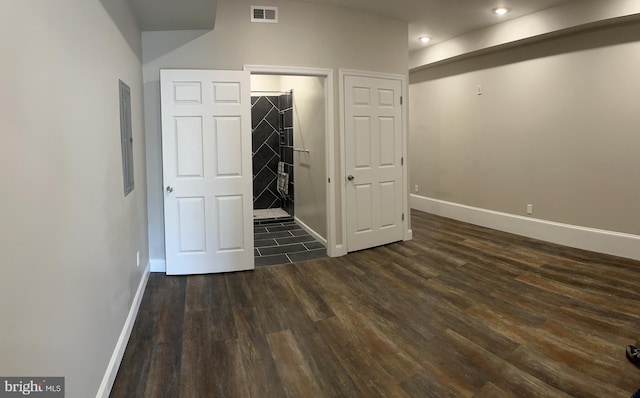 unfurnished bedroom featuring dark wood-type flooring