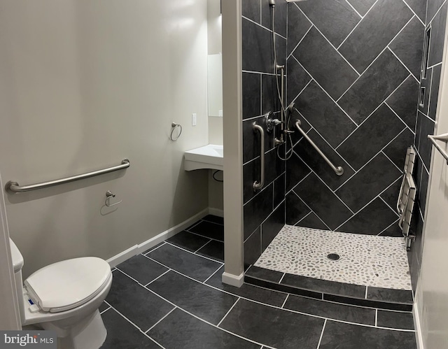 bathroom featuring toilet, tile patterned floors, and tiled shower