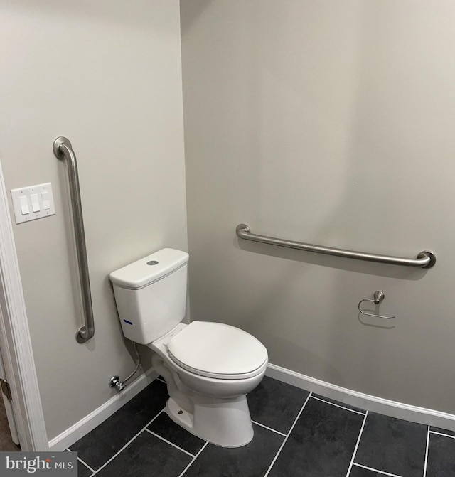 bathroom featuring toilet and tile patterned flooring