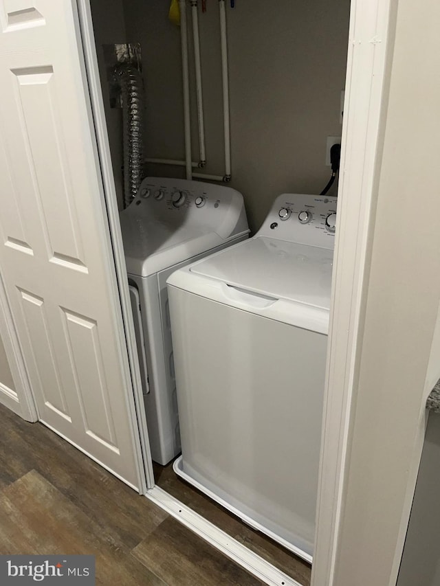 washroom featuring separate washer and dryer and dark hardwood / wood-style floors