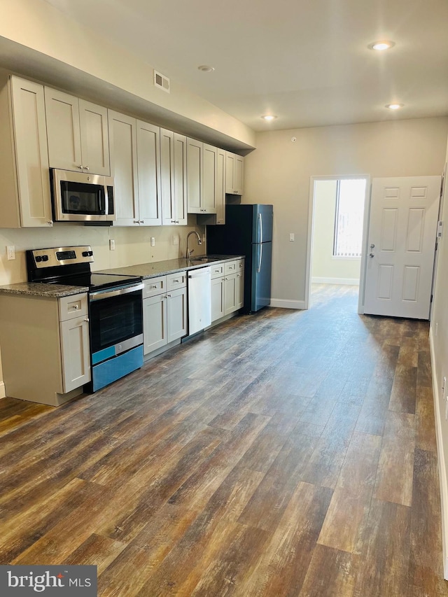 kitchen with white cabinetry, dark hardwood / wood-style floors, stainless steel appliances, and sink