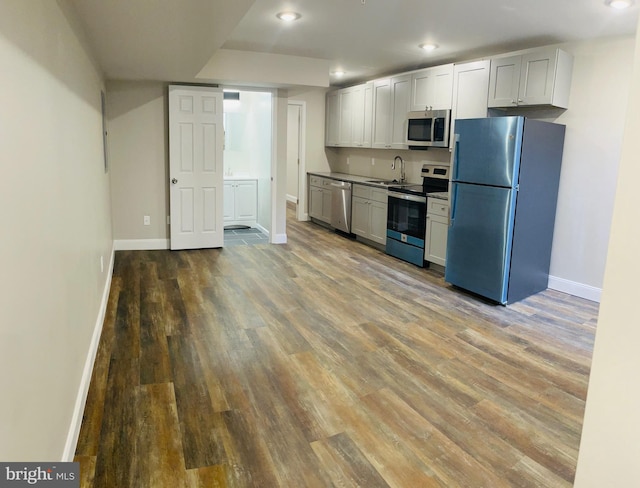 kitchen featuring gray cabinets, sink, appliances with stainless steel finishes, and light wood-type flooring