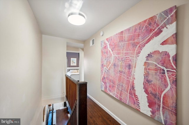 hallway with hardwood / wood-style floors