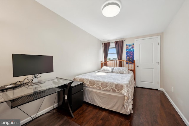 bedroom with lofted ceiling and dark hardwood / wood-style flooring