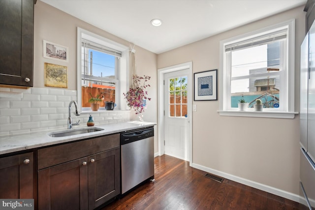 kitchen with dark hardwood / wood-style flooring, sink, stainless steel dishwasher, and dark brown cabinets