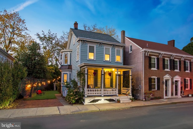 view of front of property featuring a porch and a chimney
