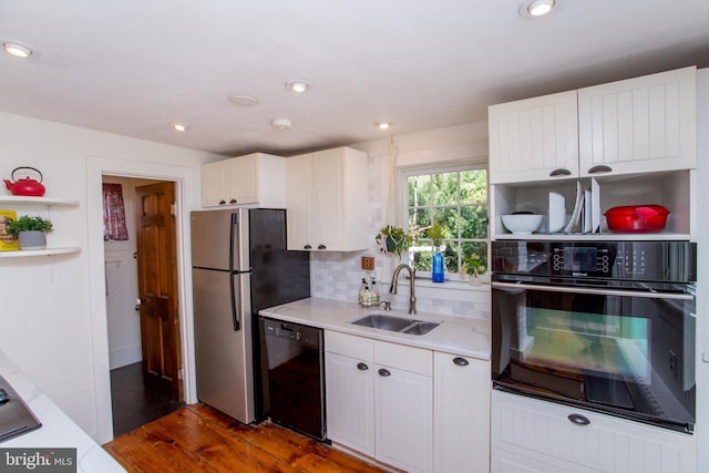 kitchen with open shelves, a sink, black appliances, decorative backsplash, and white cabinets