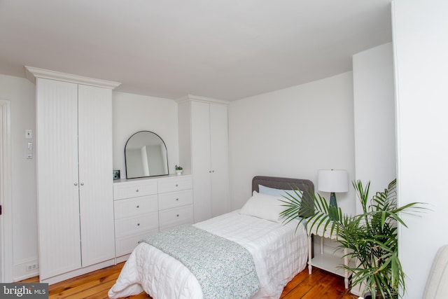 bedroom with light wood-type flooring and a closet