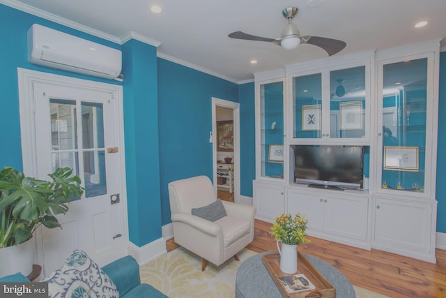 living room with an AC wall unit, ceiling fan, light wood finished floors, ornamental molding, and recessed lighting