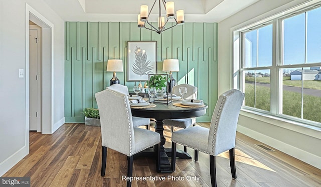 dining room featuring hardwood / wood-style flooring and a notable chandelier