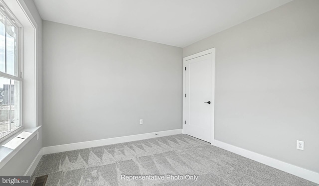 unfurnished room with light colored carpet