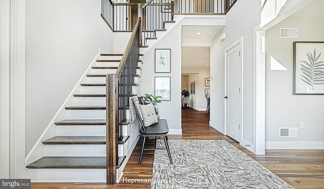 staircase with hardwood / wood-style flooring