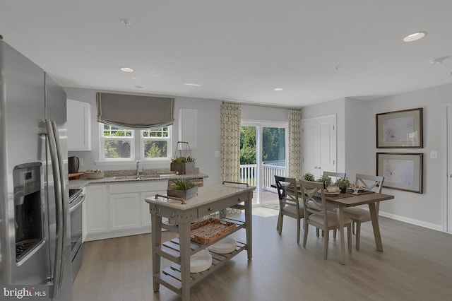 kitchen featuring white cabinets, appliances with stainless steel finishes, sink, and a wealth of natural light