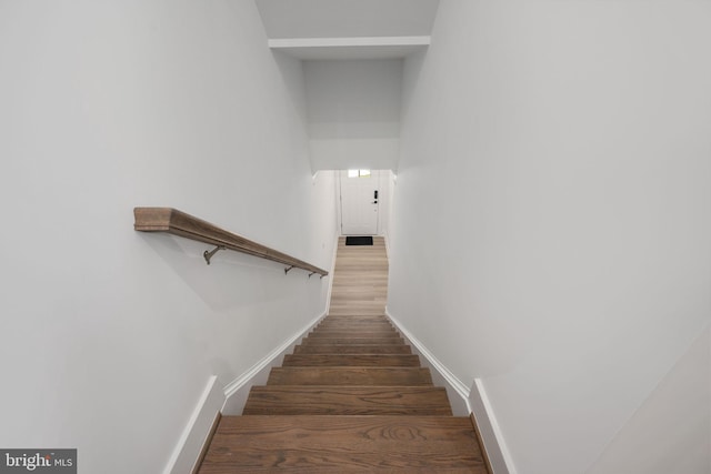 stairs with hardwood / wood-style flooring