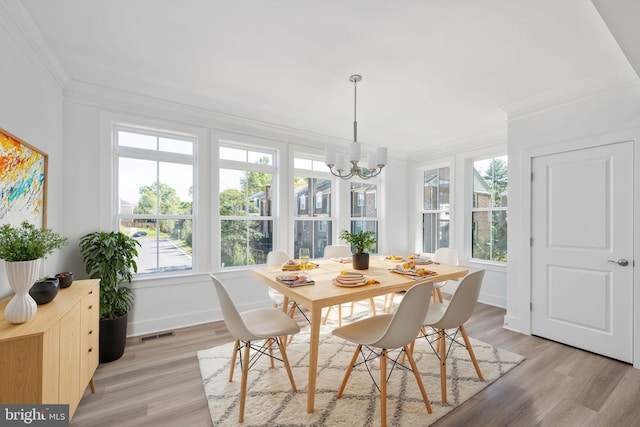 sunroom / solarium featuring a healthy amount of sunlight and a chandelier