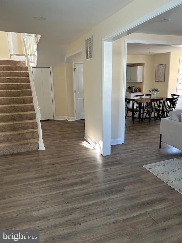 unfurnished living room with dark hardwood / wood-style floors and a healthy amount of sunlight