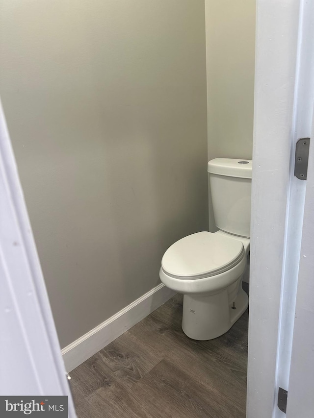 bathroom featuring wood-type flooring and toilet