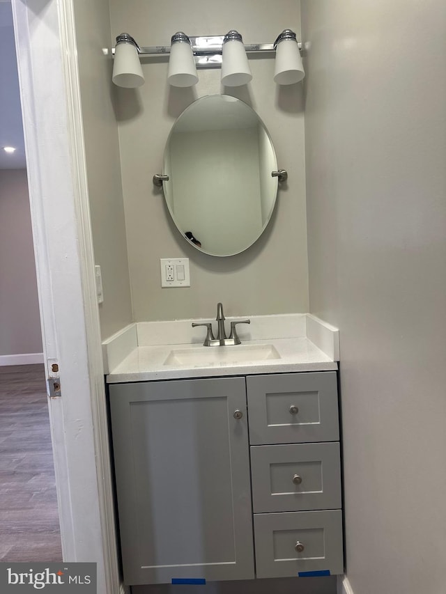 bathroom featuring hardwood / wood-style flooring and vanity