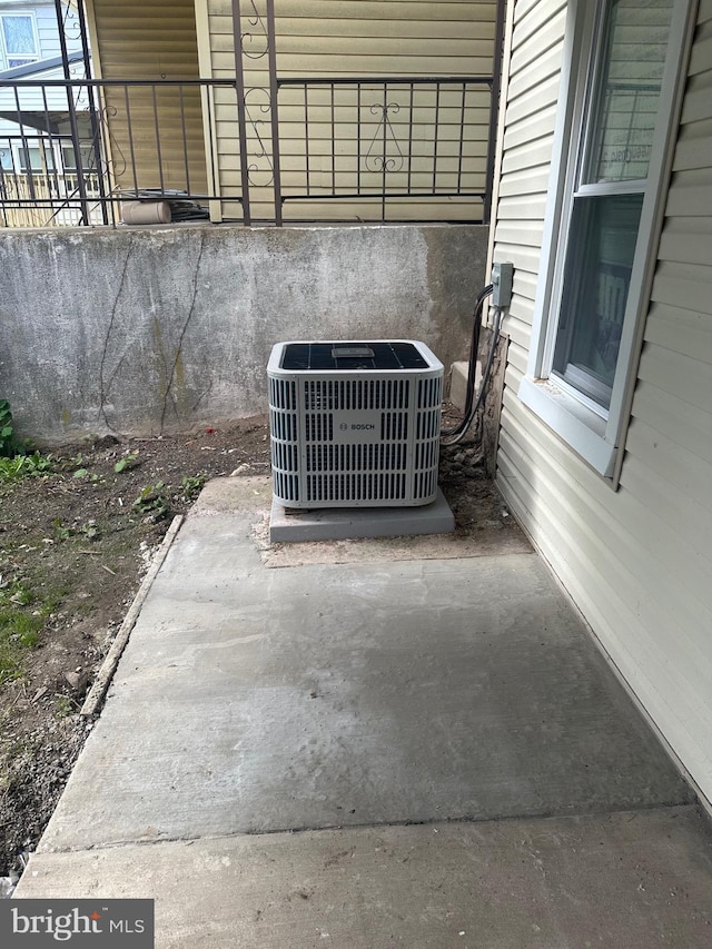 exterior details featuring cooling unit and concrete flooring