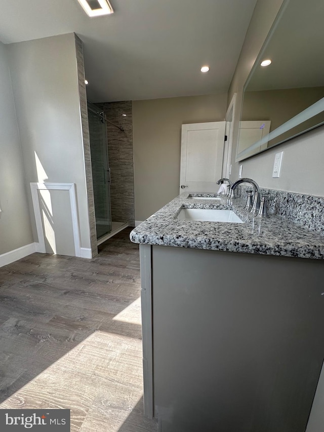 bathroom with an enclosed shower, hardwood / wood-style flooring, and vanity