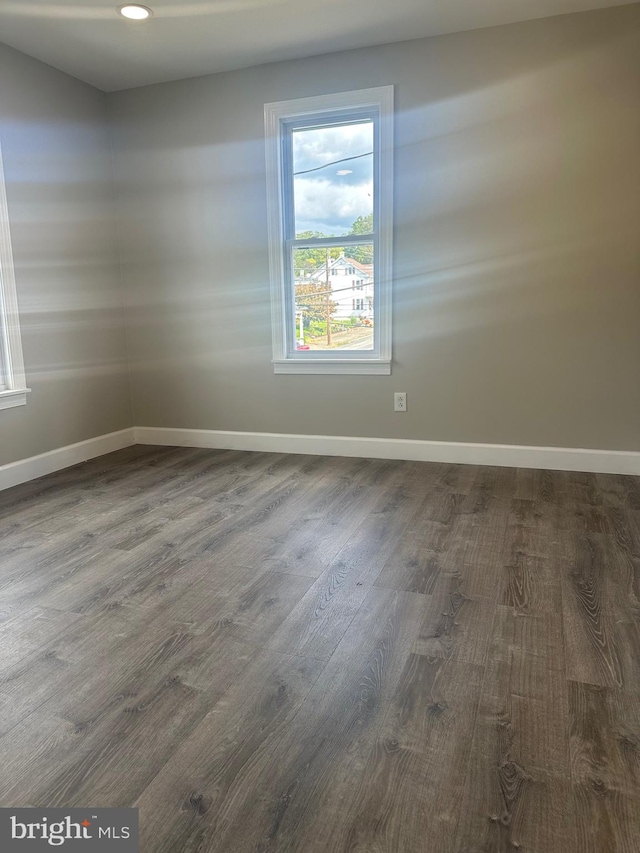 unfurnished room with hardwood / wood-style flooring