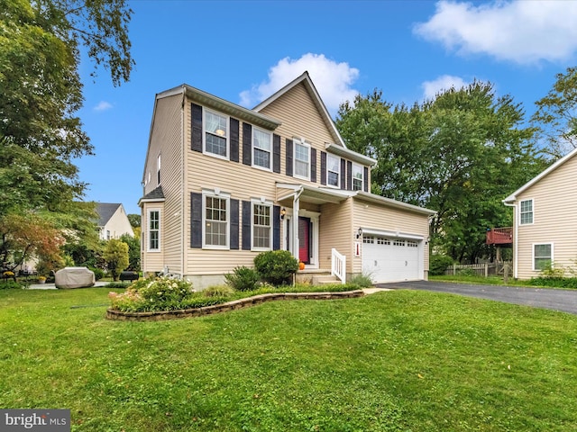 view of front of home featuring a garage and a front lawn