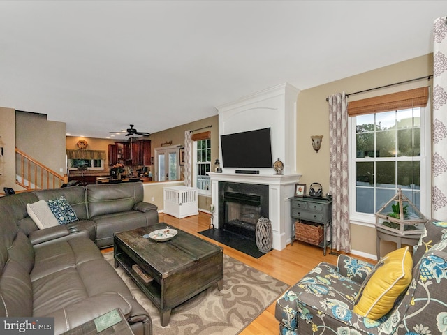 living room with light wood-type flooring and ceiling fan