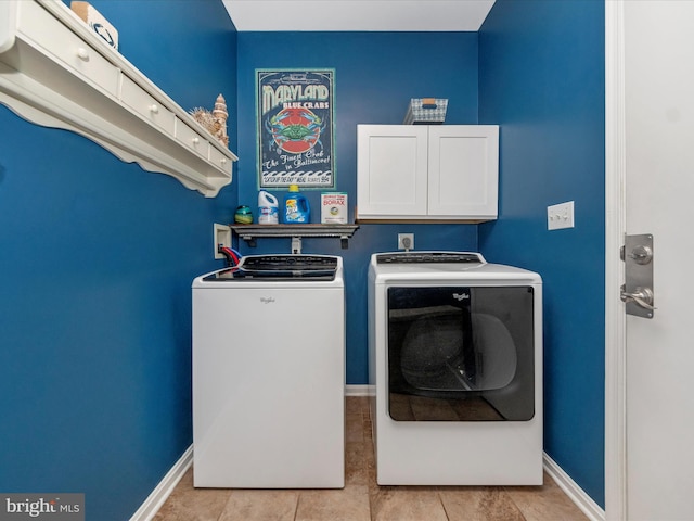 laundry area featuring washing machine and dryer and light tile patterned floors