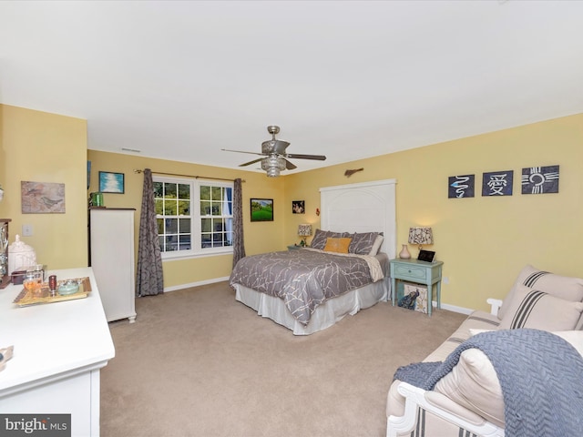 bedroom featuring light carpet and ceiling fan